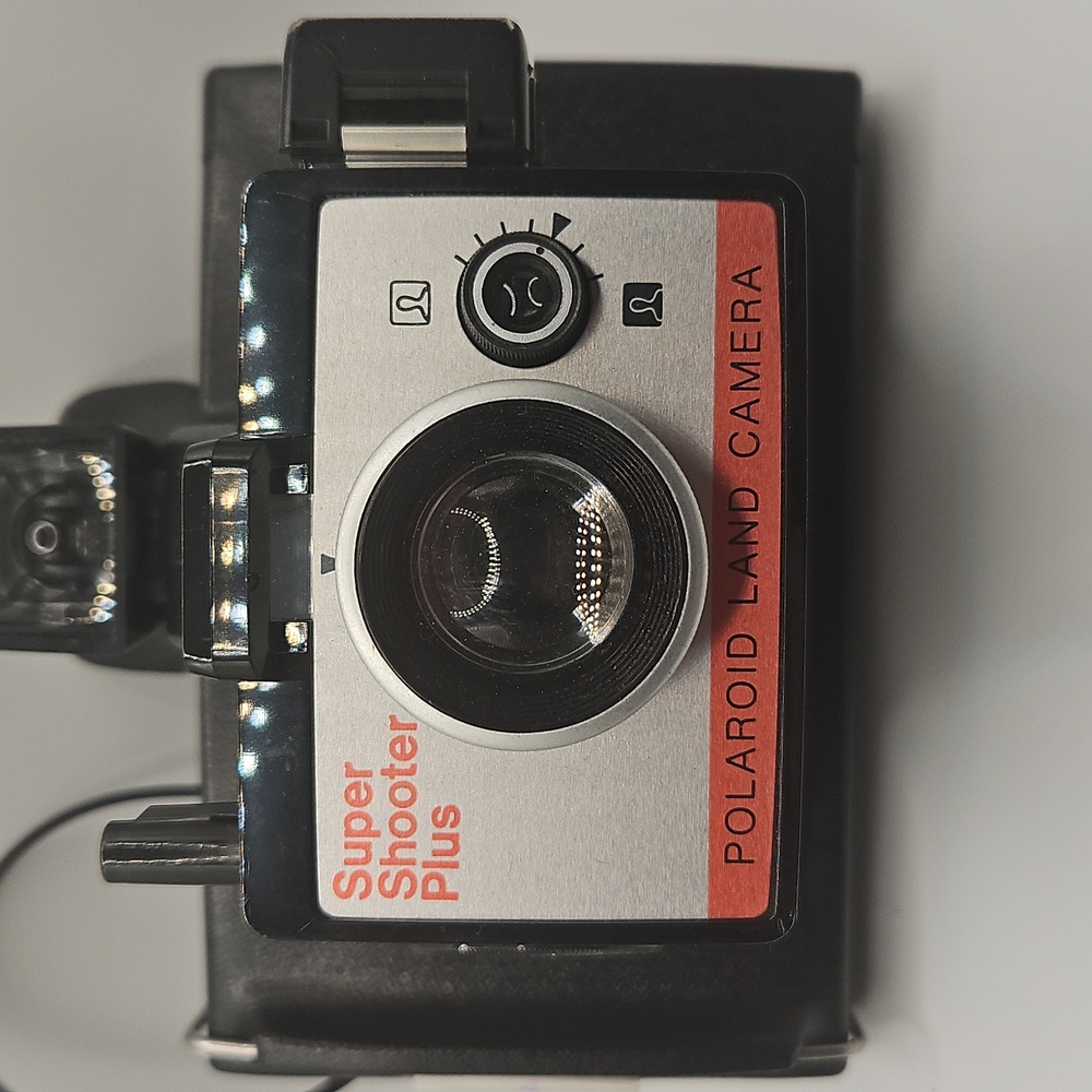 Polaroid Camera, Accessories, And Black Leather Crossbody Bag